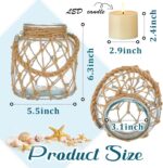 Two clear glass nautical lanterns with jute rope handles and flickering LED candles inside, on a tabletop.