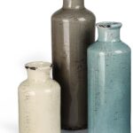 Set of three CUCUMI ceramic vases in distressed morandi colors, displayed on a shelf, showcasing rustic and coastal style.