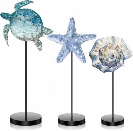 Three wooden tabletop signs in blue featuring a starfish, sea turtle, and shell, standing on individual bases.