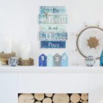 MODE HOME wooden wall plaque with a blue distressed finish, featuring a white starfish and the text "The Beach is My Happy Pl
