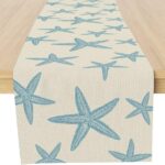 A Muktoujaumai blue starfish burlap table runner, 13x72 inches, laid flat on a dining table, showcasing its star pattern.