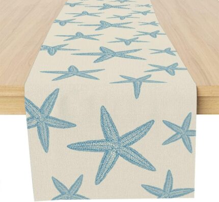 A Muktoujaumai blue starfish burlap table runner, 13x72 inches, laid flat on a dining table, showcasing its star pattern.