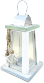 A white and blue wooden lantern candle holder with nautical ropes and a starfish, sitting on a surface.