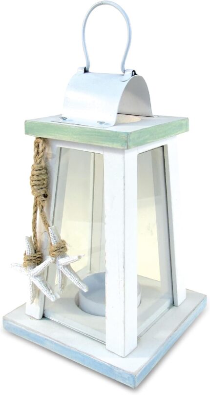 A white and blue wooden lantern candle holder with nautical ropes and a starfish, sitting on a surface.