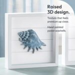 A set of four 7x7 inch framed 3D coastal wall art pieces featuring hand-painted seashells, conch shells, and starfish in past