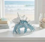 A vibrant blue hermit crab statue with its shell, designed for coastal or beach-themed home decor.