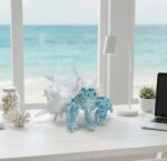 A vibrant blue hermit crab statue with its shell, designed for coastal or beach-themed home decor.